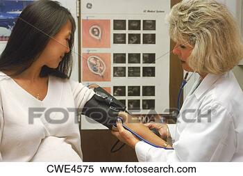 Stock Image - nurse checking 
blood pressure 
of pregnant woman 
at medical clinic. 
fotosearch - search 
stock photos, 
pictures, images, 
and photo clipart