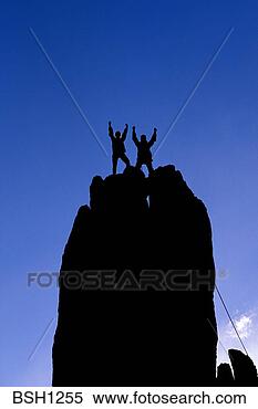 Stock Image - silhouetted climbers 
celebrating on 
the summit of 
eichorn pinnacle. 
fotosearch - search 
stock photos, 
pictures, images, 
and photo clipart