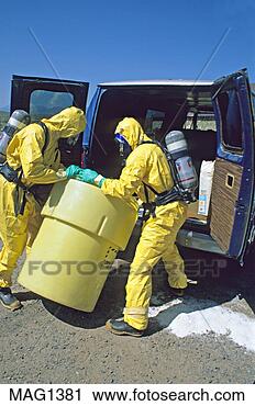 Stock Photography - hazmat team places 
steel drum into 
plastic safety 
container. fotosearch 
- search stock 
photos, pictures, 
images, and photo 
clipart