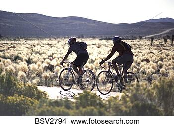Stock Photo - two men cycling 
through death 
valley california 
past flowers in 
bloom. fotosearch 
- search stock 
photos, pictures, 
images, and photo 
clipart