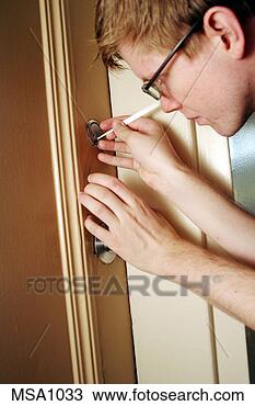 Stock Photo - man using lockpicking 
tools. fotosearch 
- search stock 
photos, pictures, 
images, and photo 
clipart