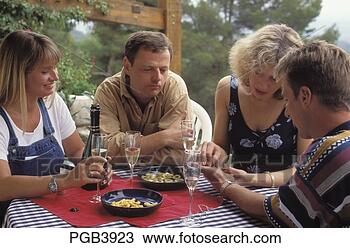 Stock Photo - four friends sitting 
outside on the 
terrace with a 
bottle of. fotosearch 
- search stock 
photos, pictures, 
images, and photo 
clipart