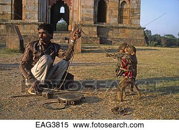 Stock Image - man and his performing 
monkeys in the 
lodi gardens - 
delhi, india. 
fotosearch - search 
stock photos, 
pictures, images, 
and photo clipart