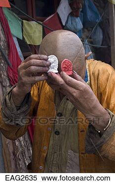 Stock Image - tibetan buddhist 
tsa tsas are received 
by a devout buddhist. 
fotosearch - search 
stock photos, 
pictures, images, 
and photo clipart