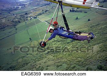Stock Photograph - hang-gliding student 
suji,  flies for 
the first time 
in a tandem hang. 
fotosearch - search 
stock photos, 
pictures, images, 
and photo clipart