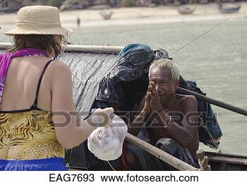 Stock Photo - north andaman 
tsunami relief 
staff deliver 
food to a moken 
man near. fotosearch 
- search stock 
photos, pictures, 
images, and photo 
clipart