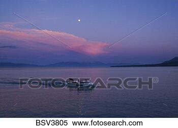 Stock Image - the full moon, 
 a power boat, 
 and a thunderhead 
cloud over lake. 
fotosearch - search 
stock photos, 
pictures, images, 
and photo clipart