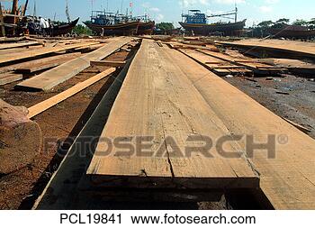Stock Photography - boatyard, phuoc 
hai, planks of 
wood drying. fotosearch 
- search stock 
photos, pictures, 
images, and photo 
clipart