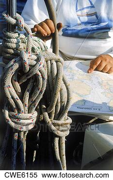 Stock Image - man at helm of 
sailboat with 
compass, charts 
and rigging. fotosearch 
- search stock 
photos, pictures, 
images, and photo 
clipart