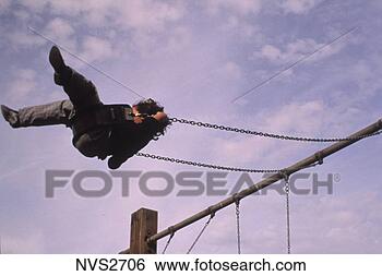 Stock Photo - child swinging 
high on an outdoor 
swing set on a 
cloudy day. fotosearch 
- search stock 
photos, pictures, 
images, and photo 
clipart