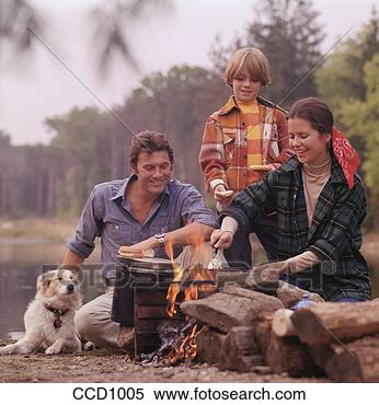 Stock Image - husband,  wife 
and son cooking 
over a campfire 
with their dog 
next to. fotosearch 
- search stock 
photos, pictures, 
images, and photo 
clipart