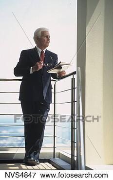 Picture - middle-aged,  
white hair business 
executive standing 
on an office. 
fotosearch - search 
stock photos, 
pictures, images, 
and photo clipart