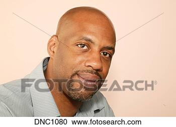 Stock Photography - studio shot of 
an african-american 
man with a casual 
smile. fotosearch 
- search stock 
photos, pictures, 
images, and photo 
clipart