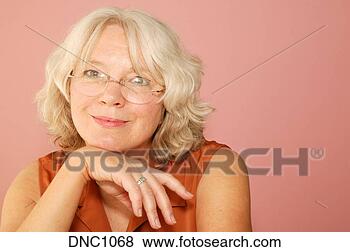 Stock Photo - studio shot of 
a blonde middle-aged 
woman with her 
chin on her hand. 
fotosearch - search 
stock photos, 
pictures, images, 
and photo clipart