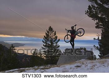 Stock Photo - a man mountain 
biking in winter 
above lake tahoe. 
fotosearch - search 
stock photos, 
pictures, images, 
and photo clipart