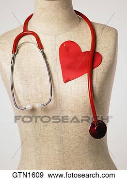 Stock Photograph - frontal view of 
a dressmakers 
form with a red 
satin heart pinned 
to. fotosearch 
- search stock 
photos, pictures, 
images, and photo 
clipart
