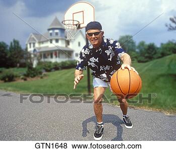Stock Photo - a humorous image 
of an active senior 
dribbling a basketball. 
fotosearch - search 
stock photos, 
pictures, images, 
and photo clipart