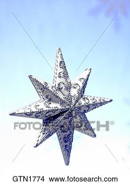 Stock Photo - a glittering christmas 
star floating 
on a blue background. 
fotosearch - search 
stock photos, 
pictures, images, 
and photo clipart