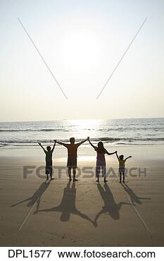 Picture - south asian indian 
parent and children 
holding hands 
facing the sun. 
fotosearch - search 
stock photos, 
pictures, images, 
and photo clipart