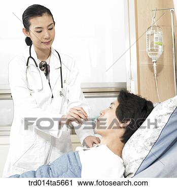 Stock Photography - medicine/ a doctor 
and a patient 
with a thermometer. 
fotosearch - search 
stock photos, 
pictures, images, 
and photo clipart