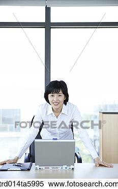 Stock Image - a businesswoman 
in front of a 
notebook. fotosearch 
- search stock 
photos, pictures, 
images, and photo 
clipart