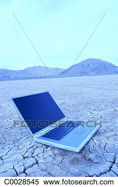 Stock Image - blue tone of an 
open laptop sitting 
on cracked desert 
floor with. fotosearch 
- search stock 
photos, pictures, 
images, and photo 
clipart
