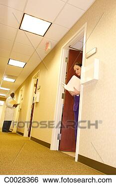 Stock Photo - looking in a doctor’s 
office to see 
a nurse checking 
a patient file. 
fotosearch - search 
stock photos, 
pictures, images, 
and photo clipart