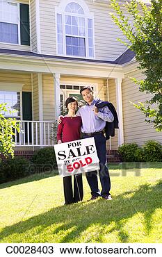 Stock Photo - portrait of a 
happy couple standing 
in front of the 
home they just. 
fotosearch - search 
stock photos, 
pictures, images, 
and photo clipart