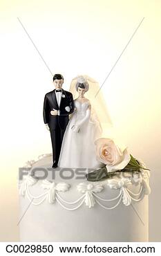 Stock Photography - wedding cake with 
a miniature bride 
and groom cake 
topper and one. 
fotosearch - search 
stock photos, 
pictures, images, 
and photo clipart