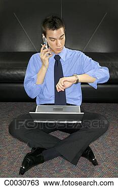 Stock Photo - a businessman 
sits on the floor 
with his laptop 
talking on a cell. 
fotosearch - search 
stock photos, 
pictures, images, 
and photo clipart