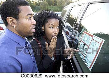 Stock Photograph - a couple points 
and is shocked 
at the sticker 
price of a new 
car in. fotosearch 
- search stock 
photos, pictures, 
images, and photo 
clipart
