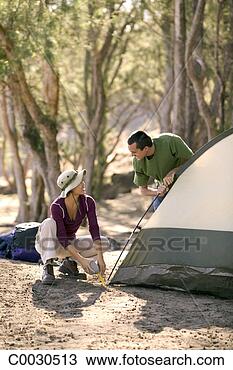 Stock Photo - a couple sets 
up a tent at a 
campsite. fotosearch 
- search stock 
photos, pictures, 
images, and photo 
clipart