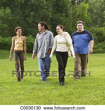 Stock Photography - four friends walk 
in a grassy field 
toward the viewer. 
fotosearch - search 
stock photos, 
pictures, images, 
and photo clipart