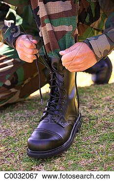 Picture - close-up of a 
military soldier 
tightening and 
tying the left 
boot. fotosearch 
- search stock 
photos, pictures, 
images, and photo 
clipart