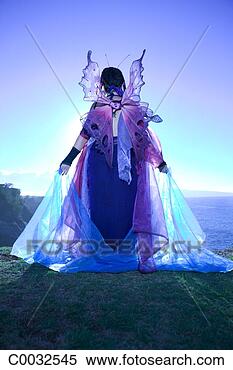 Stock Image - blue tone rear 
view of a backlit 
fairy standing 
at the edge of 
a cliff. fotosearch 
- search stock 
photos, pictures, 
images, and photo 
clipart