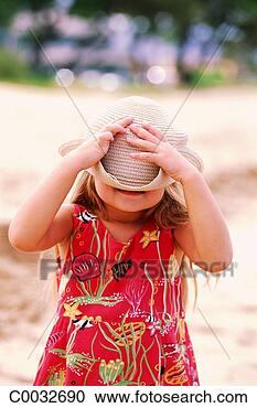 Stock Photography - a female child 
standing in the 
sand wearing a 
red print dress 
pulling. fotosearch 
- search stock 
photos, pictures, 
images, and photo 
clipart