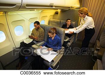 Stock Image - a flight attendant 
hands a passenger 
a blanket. fotosearch 
- search stock 
photos, pictures, 
images, and photo 
clipart