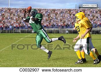 Picture - football player 
successfully catches 
the ball while 
opposing players. 
fotosearch - search 
stock photos, 
pictures, images, 
and photo clipart