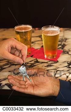 Stock Photo - high angle view 
of a man handing 
over his keys 
after drinking 
in a bar. fotosearch 
- search stock 
photos, pictures, 
images, and photo 
clipart