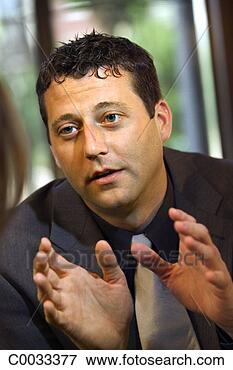 Picture - a man uses his 
hands as he talks 
to his unseen 
date while in 
a. fotosearch 
- search stock 
photos, pictures, 
images, and photo 
clipart
