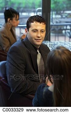 Stock Photograph - an over the shoulder 
view of a man 
and woman talking 
over dinner in 
a. fotosearch 
- search stock 
photos, pictures, 
images, and photo 
clipart