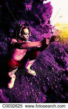 Stock Image - pink tone of a 
futuristic man 
squatting on rocks 
shooting a yellow. 
fotosearch - search 
stock photos, 
pictures, images, 
and photo clipart