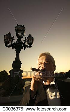 Stock Image - portrait of a 
man in paris wearing 
a tuxedo and smoking 
a cigar. fotosearch 
- search stock 
photos, pictures, 
images, and photo 
clipart