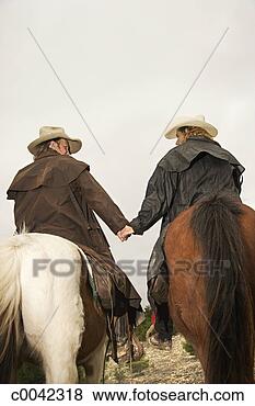 Stock Photo - cowboy and cowgirl 
on horses. fotosearch 
- search stock 
photos, pictures, 
images, and photo 
clipart