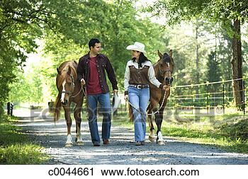 Stock Photography - couple leading 
horses down country 
road. fotosearch 
- search stock 
photos, pictures, 
images, and photo 
clipart