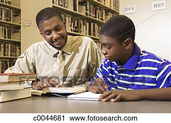 Stock Photography - man tutoring teen 
boy in library. 
fotosearch - search 
stock photos, 
pictures, images, 
and photo clipart