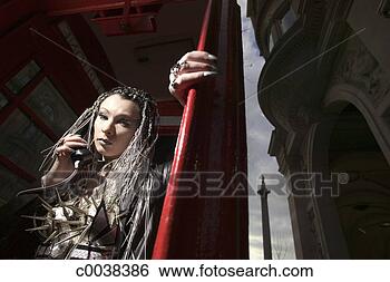 Stock Photo - goth woman talking 
in phone booth. 
fotosearch - search 
stock photos, 
pictures, images, 
and photo clipart