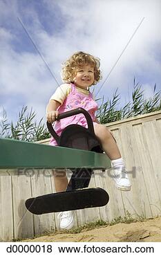 Stock Photo - little girl on 
see-saw. fotosearch 
- search stock 
photos, pictures, 
images, and photo 
clipart