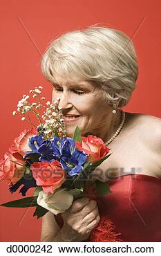 Stock Photo - older woman in 
formal gown sniffing 
bouquet. fotosearch 
- search stock 
photos, pictures, 
images, and photo 
clipart