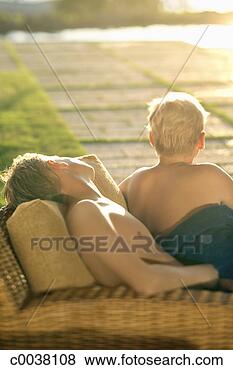 Stock Photo - two boys lying 
on lounge chairs 
in the afternoon. 
fotosearch - search 
stock photos, 
pictures, images, 
and photo clipart